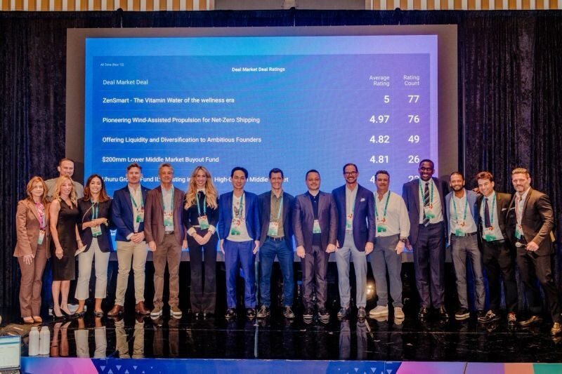 Founders and investors on stage at a deal market showcase